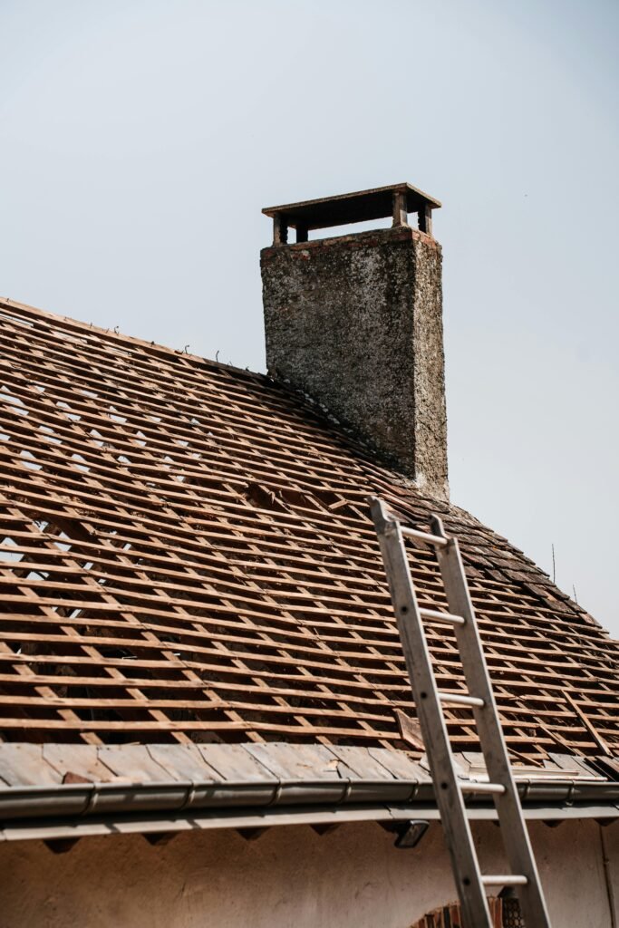 pexels photo 31763534 31763534 A traditional rooftop under renovation with visible chimney and ladder.